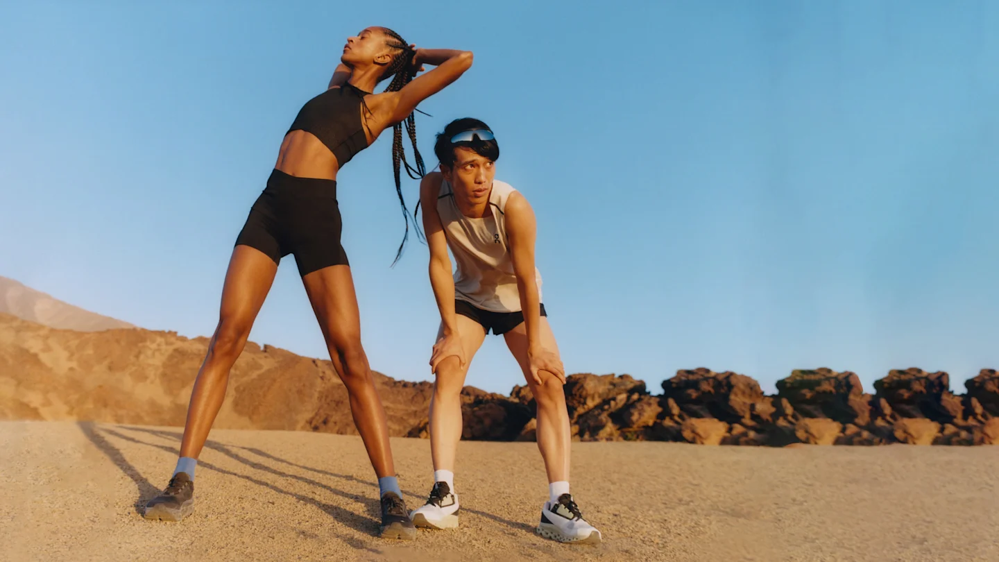 Two runners taking a break on a hard run through the desert.